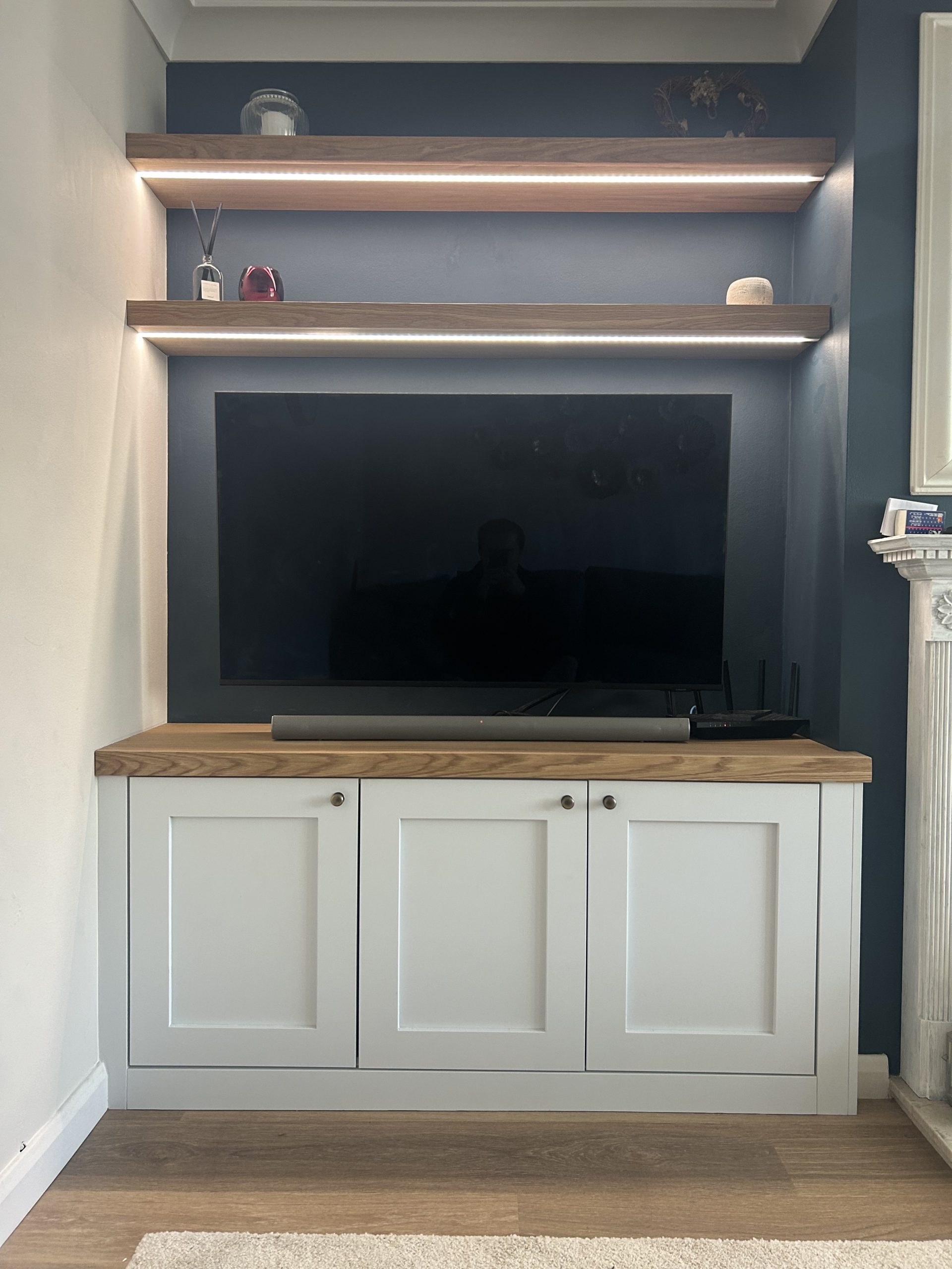 Bespoke alcove unit with solid oak shelving and concealed LED lighting, fitted in Henley-on-Thames